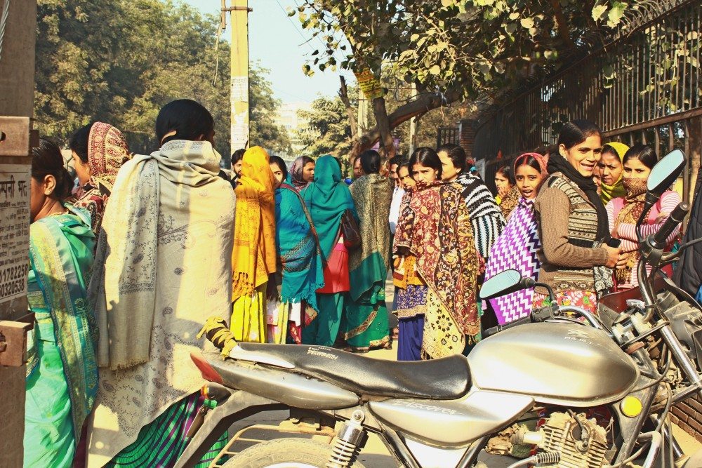 Female workers gather at one point, some waiting for the rides to the factories and some waiting to be selected by the factory contractors.